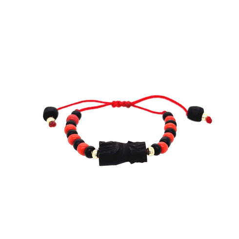 The Genuine Azabache Hand Baby Bracelet showcases a pattern of alternating red and black beads centered around a black carved bead, symbolizing spiritual protection. It is finished with adjustable red strings adorned with black and red bead ends, echoing the style of an Azabache Baby Bracelet.